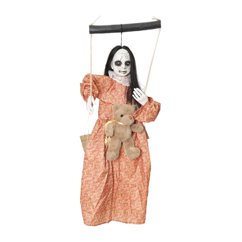 Hanging creepy cracked-face doll on a swing 